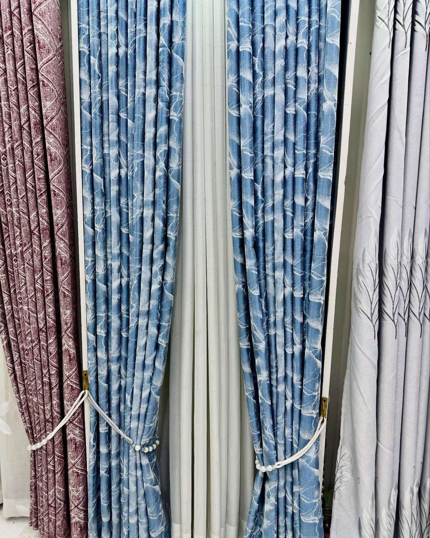Modern curtain design 2025 showcasing bold patterns and luxurious fabric textures.