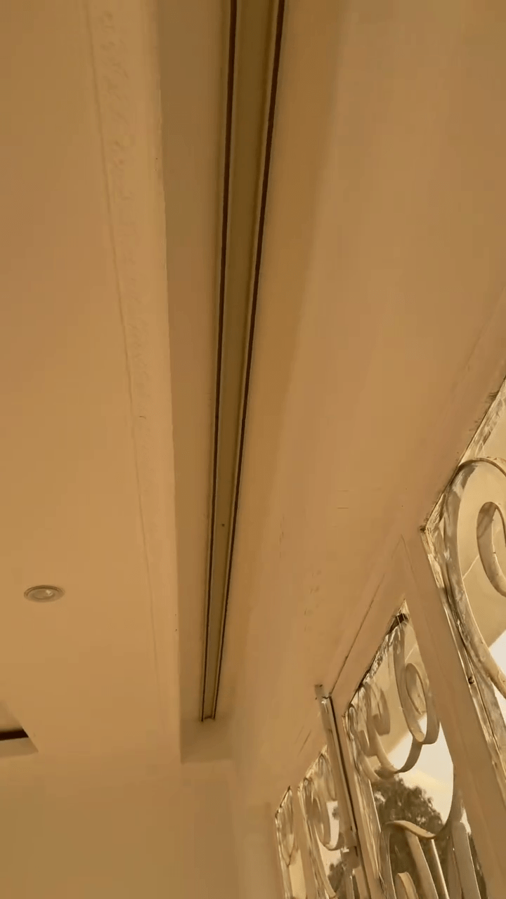 Ceiling-mounted curtain rails providing a modern, sleek look for minimalist room designs.