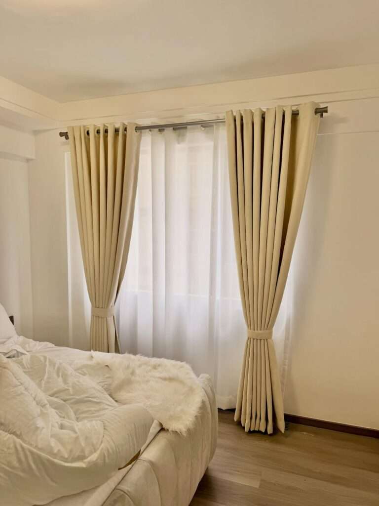 Energy saving curtains installed in a sunlit living room to reduce indoor heat